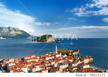 Panoramic sunset aerial drone view of the ancient city of Budva, Montenegro and St Nicholas island. Old medieval town. Panoramic sunset aerial drone view of the ancient city of Budva, Montenegro and St Nicholas island. Old medieval town. 96613372