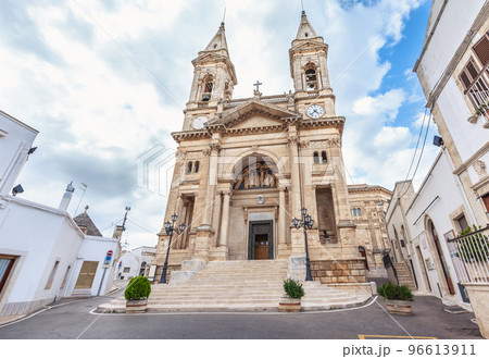 Alberobello, Puglia, Italy. View of the Famous village with Cathedral of Saints Cosmas and Damian. 96613911