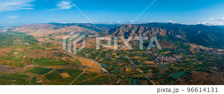 Sicilian vineyards with Etna volcano eruption at background in Sicily, Italy. Rural Sicilian landscape 96614131