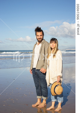Nice couple walking near water on summer day Nice couple walking near water on summer day 96614660