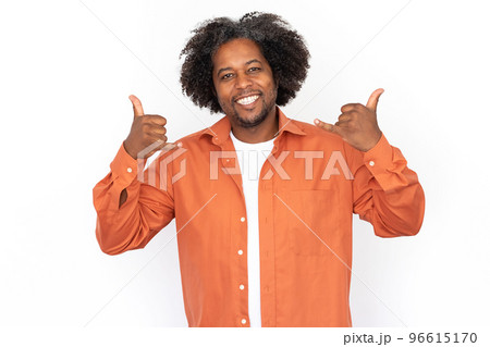 Portrait of cheerful mid adult man making phone or rock gesture 96615170