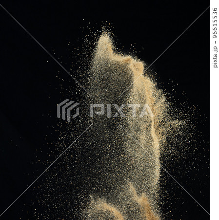 Sand flying explosion, Golden sand wave explode. Abstract sands cloud fly. Yellow colored sand splash throwing in Air. black background Isolated high speed shutter, throwing freeze stop motion 96615536