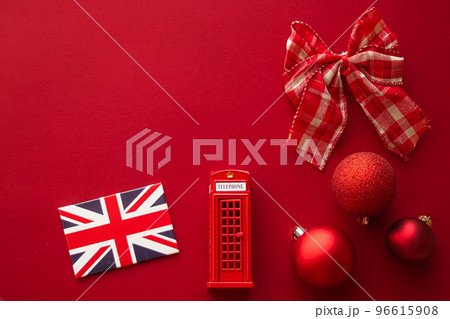 Christmas holiday tradition in United Kingdom and happy holidays flat lay, british flag, London telephone box and xmas decoration on festive red background as flatlay design, top view Christmas holiday tradition in United Kingdom and happy holidays flat lay, british flag, London telephone box and xmas decoration on festive red background as flatlay design, top view 96615908