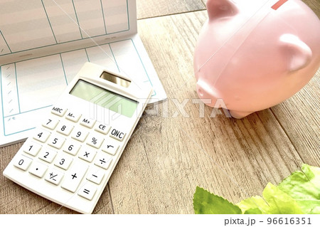 白色の電卓と通帳とブタの貯金箱 96616351