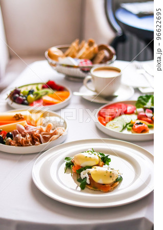 Luxury hotel and five star room service, various food platters, bread and coffee as in-room breakfast for travel and hospitality brand 96622695