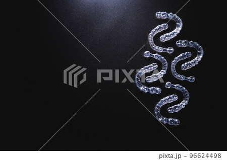 pattern of transparent plastic braces on a black background with free space for advertising pattern of transparent plastic braces on a black background with free space for advertising 96624498