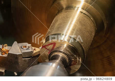 Close up scene the lathe machine finish cut the brass shaft parts by insert tools. 96624809