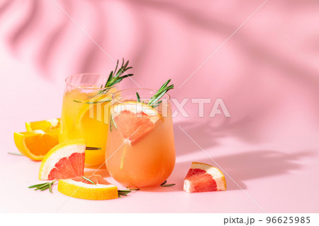 Summer cocktails with grapefruit, orange, rosemary, and ice. Summer cocktails with grapefruit, orange, rosemary, and ice. 96625985