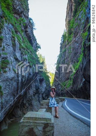 Woman in dress and straw hat in Bicaz Canyon 96626842