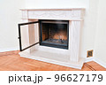 Stylish modern fireplace with a fireproof glass door in a rich house 96627179