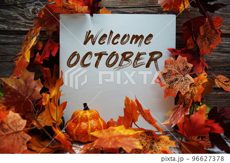 Welcome October text message with autumn maple leaves and pumpkins on wooden background Welcome October text message with autumn maple leaves and pumpkins on wooden background 96627378
