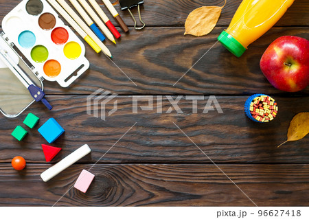 Back to school background with school supplies, autumn leaves and apple on a wooden table, copy space. Back to school background with school supplies, autumn leaves and apple on a wooden table, copy space. 96627418