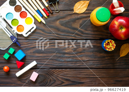 Back to school background with school supplies, autumn leaves and apple on a wooden table, copy space. Back to school background with school supplies, autumn leaves and apple on a wooden table, copy space. 96627419