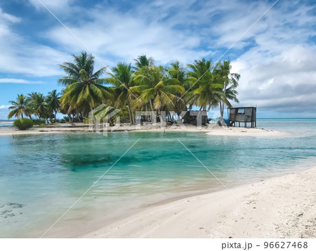 Wild tropical island with turquoise water and coconut palm trees. Crystal sea, white sand beach. Amazing nature background. Travel, adventure, tourism, relax. Popular tourist destination in Polynesia 96627468