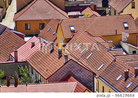 Aerial view of roofs of houses standing close together in medieval European village Aerial view of roofs of houses standing close together in medieval European village 96629668