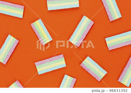 Licorice Candy. Sweet gummy sticks with different flavor, on orange background. 96631392