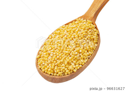 Dry millet groats in a wooden spoonl, isolated on white background. Full depth of field. 96631627