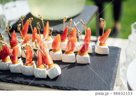 Sandwiches, canapes and cakes on the festive table. A wide variety of snacks 96632153