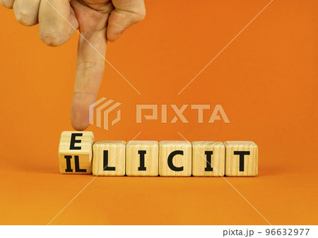 Illicit or elicit symbol. Businessman turns wooden cubes and changes the concept word Illicit to Elicit. Beautiful orange table orange background. Business illicit or elicit concept. Copy space. 96632977