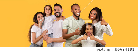Happy middle eastern and african american families on yellow Happy middle eastern and african american families on yellow 96634191