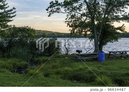 Blue plastic barrel for garbage in a park near Rockland Lake, New York.  96634487