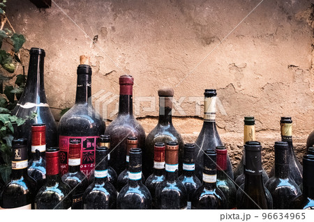 Old open red wine bottles dusted by time 96634965