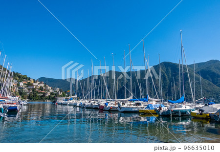 Sailboats docked at lake lugano on a summer day Sailboats docked at lake lugano on a summer day 96635010