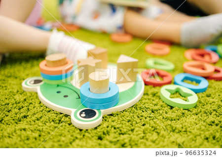 Little children play with wooden toys in kindergarden Little children play with wooden toys in kindergarden 96635324