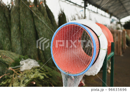 Red christmas tree wrapping device Packed in a plastic net Red christmas tree wrapping device Packed in a plastic net 96635696