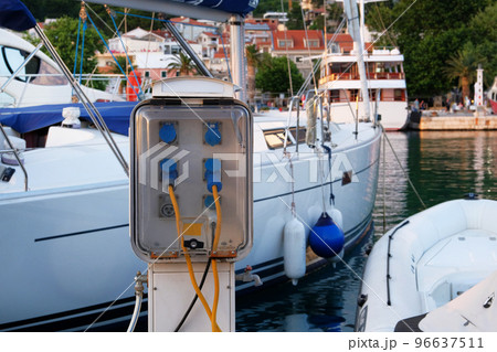 Electrical outlets for charging on boats in sea coast in Mediterranean. Charging station for boats. Horizontal frame. Electrical outlets for charging on boats in sea coast in Mediterranean. Charging station for boats. Horizontal frame. 96637511