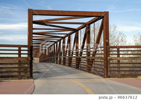 footbridge and bike trail over a river 96637612