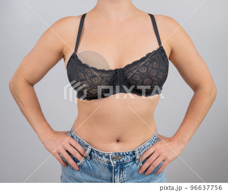 Close-up of a woman's breasts in a bra. A woman - Stock Photo