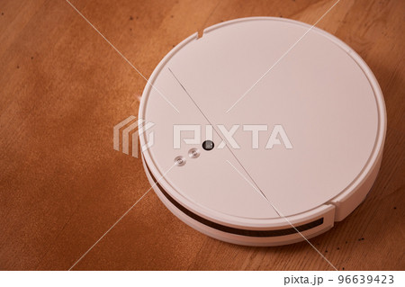 Robot vacuum cleaner cleans the very dirty dusty floor of the apartment at a certain time. Robot vacuum cleaner cleans the very dirty dusty floor of the apartment at a certain time. 96639423