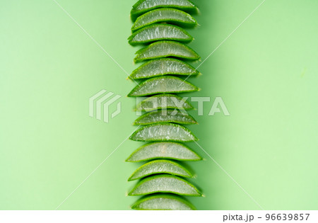 Aloe vera leaves cuts background. Aloe it is a succulent herbaceous plant. Widely used in medicine and cosmetics. Aloe vera leaves cuts background. Aloe it is a succulent herbaceous plant. Widely used in medicine and cosmetics. 96639857