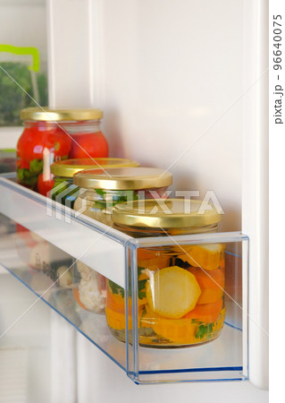 Variety glass jars homemade pickled vegetables on shelf of refrigerator. Fermented healthy natural vegetarian food concept. 96640075