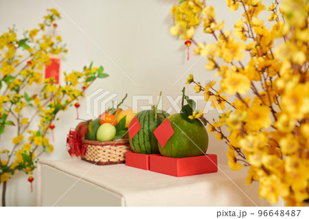 Fresh fruits and blooming apricot branches for Tet celebration Fresh fruits and blooming apricot branches for Tet celebration 96648487