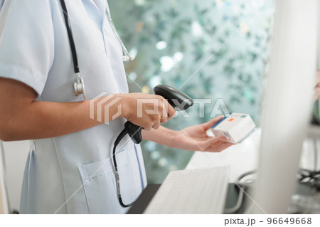Medicine and health concept, Female pharmacist scanning medicine product barcode in cash register 96649668