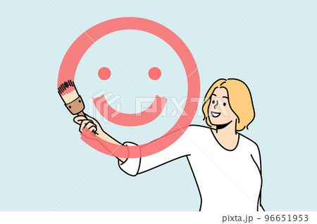 Girl paints smiling face with brush and red paint. 96651953