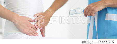 Examination by woman gynecologist, doctor touch belly, clinic appointment 96654315