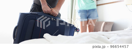 Guy carry heavy luggage, man leaving home for work trip 96654457