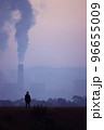 silhouette of a man standing watching a coal power plant There are high chimneys that emit smoke from the combustion energy of the transfer stone, concept environmental destruction global warming. 96655009