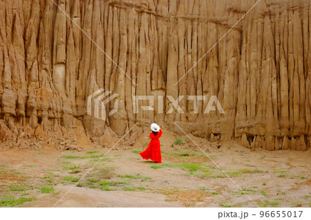 Women and landscape of soil textures eroded sandstone pillars, columns and cliffs, natural erosion of water and wind, Sao Din Na Noi, Hom Chom, Khok Suea at sri nan national park in Nan Province. 96655017