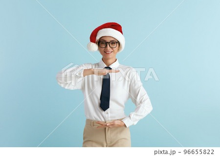 Surprised Businesswoman Showing Big Size. Satisfied Caucasian Lady in Santa Hat Surprised Businesswoman Showing Big Size. Satisfied Caucasian Lady in Santa Hat 96655822