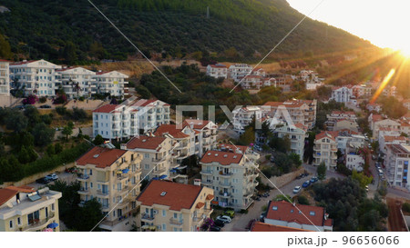 Townscape and mountains at sunset. Aerial panoramic view from above. Beautiful resort town scenery. 96656066