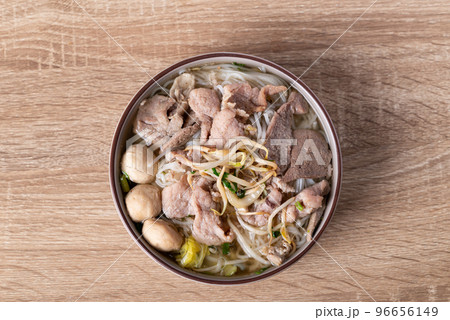 Rice noodles soup with pork in bowl on wooden background, Asian food, Table top view Rice noodles soup with pork in bowl on wooden background, Asian food, Table top view 96656149