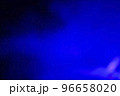 Blurred dark background with blue smoke light. 96658020