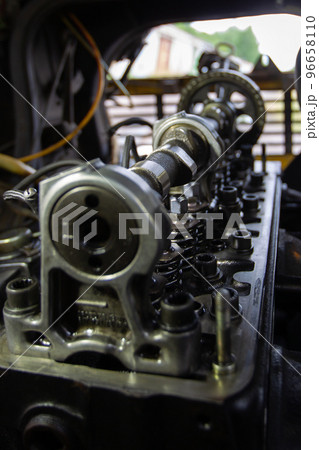 Mercedes diesel engine repair. Hands with a mechanic repairing Mercedes parts. The gas distribution mechanism of the car. Mercedes diesel engine repair. Hands with a mechanic repairing Mercedes parts. The gas distribution mechanism of the car. 96658110