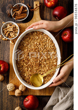 Apple crumble with oatmeal, walnuts and cinnamon. Top view 96658876