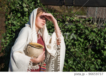 Girl with a pot in ancient clothes 96659737