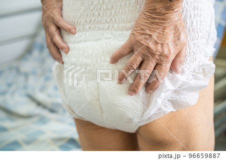Asian senior or elderly old lady woman patient wearing incontinence diaper in nursing hospital ward, healthy strong medical concept. Asian senior or elderly old lady woman patient wearing incontinence diaper in nursing hospital ward, healthy strong medical concept. 96659887